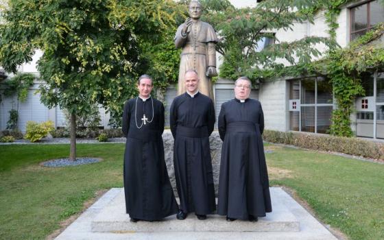 Fr. Davide Pagliarani, center, superior general of the traditionalist Society of St. Pius X is pictured during the society's general chapter in Econe, Switzerland July 12, 2018. With him are  Bishop Alfonso de la Galarreta, left, and Fr. Christian Bouchacourt. (CNS/Courtesy fsspx.news) 