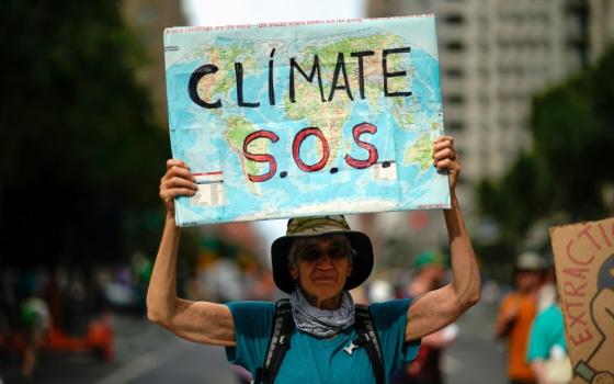 A man holds a sign during a demonstration marking the start of Climate Week in New York City, Sept. 17, 2023. (OSV News/Reuters/Eduardo Munoz)