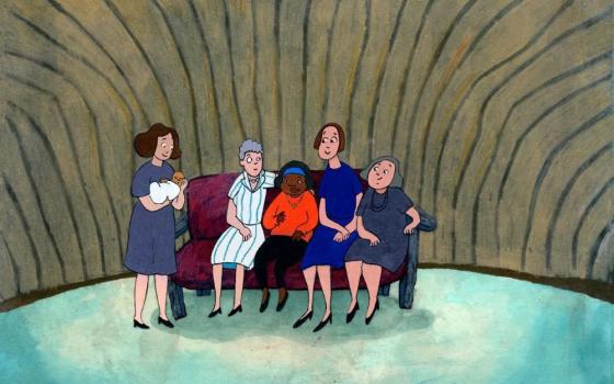 Several people sit on a couch with a Black little girl. A woman stands, holding a baby.