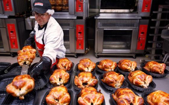 A Costco employee cooks chicken at Costco in Mountain View, Calif., March 3, 2010. The company has sold its rotisserie chicken for $4.99 since 2009. (AP/Paul Sakuma, file)
