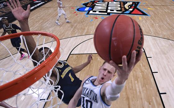 Michigan Wolverines guard Charles Matthews tries to defend a shot from Villanova Wildcats guard Donte DiVincenzo in the 2018 NCAA men's basketball championship in San Antonio. Villanova defeated Michigan, winning its second championship in three years. Villanova, Pope Leo XIV's alma mater, and the University of Notre Dame are finalizing an agreement to open the men's and women's seasons Nov. 1 in Rome. (OSV News/USA TODAY Sports via Reuters/Robert Deutsch)