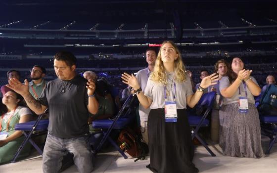 Participants pray during the opening revival night of the National Eucharistic Congress at Lucas Oil Stadium in Indianapolis July 17, 2024. The congress was the culmination of the U.S. Catholic Church's three-year National Eucharistic Revival. (OSV News/Bob Roller)