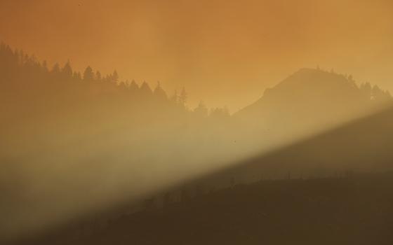 Sunlight cuts through smoke from the Pickett wildfire on Aug. 22, 2025, in Napa County, Calif. (AP/Godofredo A. Vásquez)