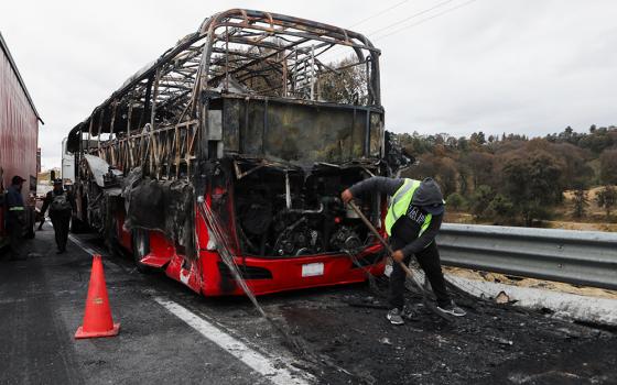 A burned bus is seen Feb. 22, 2026, at the site of a highway in Santa Rita Tlahuapan, Mexico, that connects Mexico City with the state of Puebla. Members of organized crime in several states put up roadblocks and carried out arson attacks after a military operation in which Mexican drug lord Nemesio Oseguera, known as "El Mencho," was killed in Tapalpa in Mexico's Jalisco state. (OSV News/Reuters/Paola Garcia)