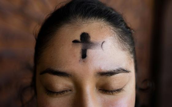 A close-up shows a person's forehead with a cross made of ashes. (Unsplash/Annika Gordon)