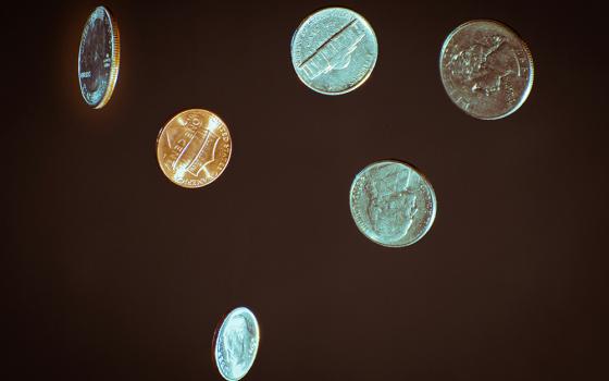 Several U.S. coins against a dark background (Unsplash/Chris Briggs)