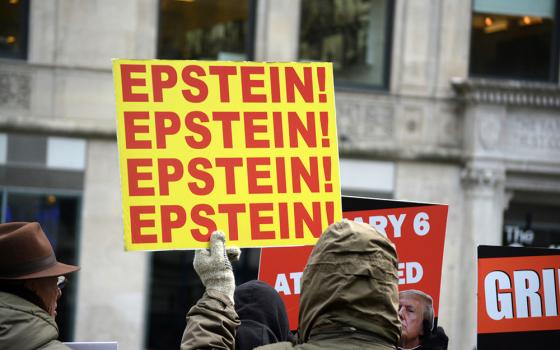 A protester holds a sign drawing attention to the Epstein files scandal during a demonstration against President Donald Trump on Jan. 6, 2026, in Manhattan, New York. (Dreamstime/Cpenler)