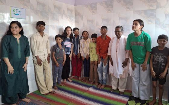 Sr. Connie Callista, a member of the Holy Cross Sisters of Chavanod, works with children doing indoor training at Trilokpuri, an enclave in East Delhi, India. (Lissy Maruthanakuzhy)