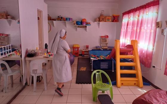 Sr. Eleanor Rosare walks through a play and therapy room at the Sacred Heart Center in Quezon City, Philippines. The Daughters of St. Mary of Providence run the center, where more than 60 children a week with autism, Down syndrome, ADHD and other developmental conditions receive support, therapy and care. (Oliver Samson) 