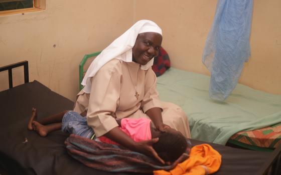 Sr. Mary Monica Amollo Owuor provides therapy support to a child at Sigomere Small Home in Siaya County, western Kenya. Many residents have living parents, but were abandoned due to poverty and stigma. (GSR photo/Doreen Ajiambo)