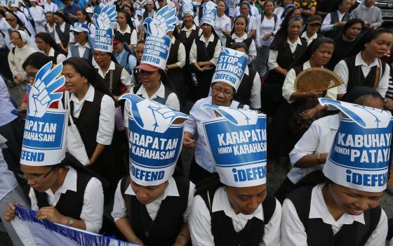 Roman Catholic nuns join hundreds of protesters as they gather at the People Power Monument to mark the 31st anniversary of the near-bloodless revolt that toppled the 20-year-rule of the late dictator Ferdinand Marcos Saturday, Feb. 25, 2017, in suburban Mandaluyong city northeast of Manila, Philippines. (AP/Bullit Marquez)