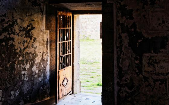 Door in a dilapidated building open to the outside (Unsplash/Eric Prouzet)