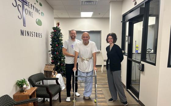 Physical therapy student Major Kelley, left, and physical therapy instructor Michelle Keller assist Stepping Stone resident Marlin Chase. (Courtesy of Sr. Idelle Badt)