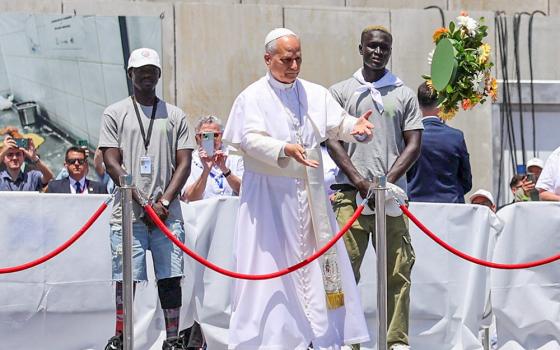 Pope Leo XIV makes a floral offering to migrants lost at sea at the dock of the Port of Arguineguin in Gran Canaria, Spain, June 11, 2026. (OSV News/Reuters/Yara Nardi)