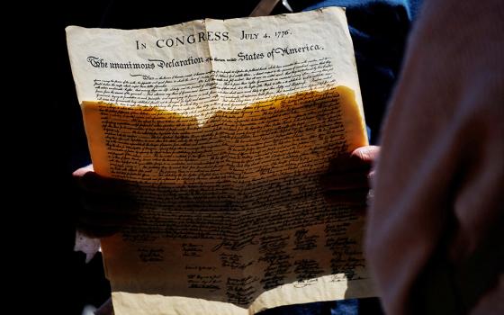 Kyle Jenks, a professional interpreter of late U.S. President James Madison, holds a copy of the Declaration of Independence while leading a tour in Philadelphia, Pennsylvania, May 1, 2026. (OSV News/Reuters/Hannah Beier)
