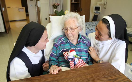 A file photo shows Dominican postulant Anna Harper and Dominican Sr. Carmela Marie visit with patient Edna MacCready at Rosary Hill Home in Hawthorne, N.Y. (OSV News/Gregory A. Shemitz)