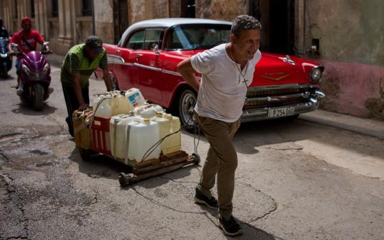 People transport containers of water in Havana June 3, 2026. (AP/Ramon Espinosa) 