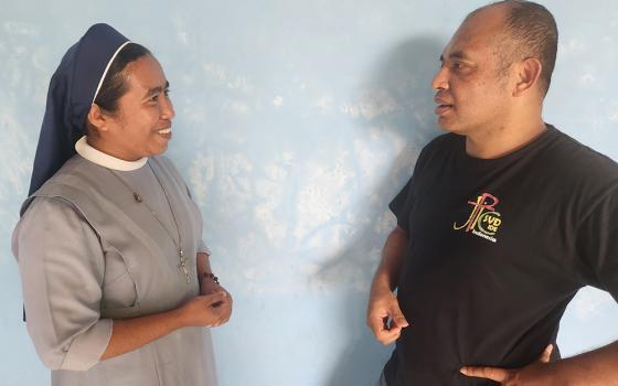Sr. Fransiska "Ika" Imakulata, left, a Missionary Sister Servant of the Holy Spirit and coordinator of TRUK F, speaks with Divine Word Missionary Fr. Laurens Woda. (GSR/Chris Herlinger)