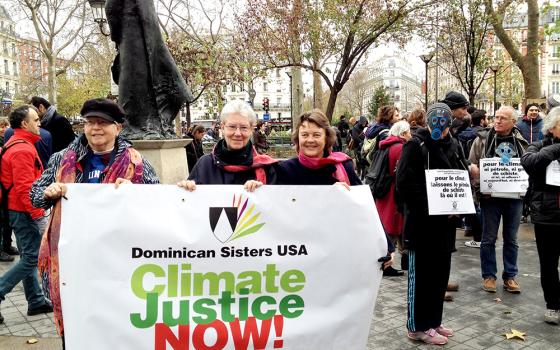 In this 2015 file photo, Adrian Dominican Sr. Patricia Siemen, Amityville Dominican Sr. Margaret Mayce and Adrian Dominican Sr. Elise García demonstrate in Paris for climate justice. (CNS/Global Sisters Report)