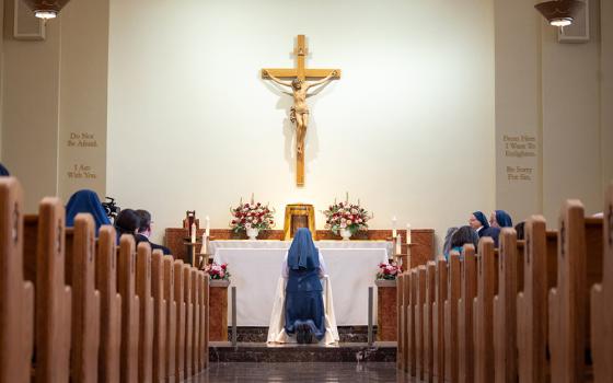Sr. Catherine Lucia Phoebe Addington of the Daughters of St. Paul in Alexandria, Virginia, is pictured kneeling in prayer during her profession of vows in Boston Feb. 14, 2026. (OSV News/Courtesy of Daughters of St. Paul)