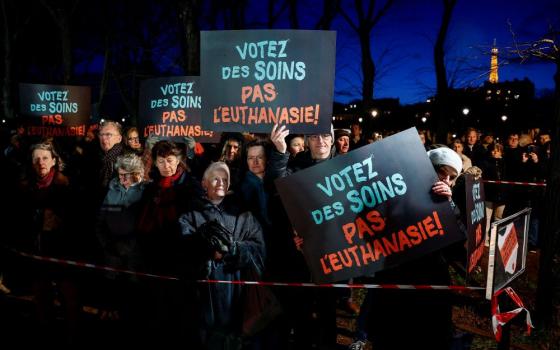 People hold placards reading, "Vote for care. Not euthanasia," during a demonstration in Paris Feb. 16, 2026, as France debates a bill to legalize "assisted dying." (OSV News/Reuters/Benoit Tessier)