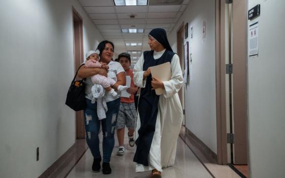A Catholic nun accompanies a family of asylum seekers inside immigration court on Aug. 1, 2025, in New York. (AP/Olga Fedorova)